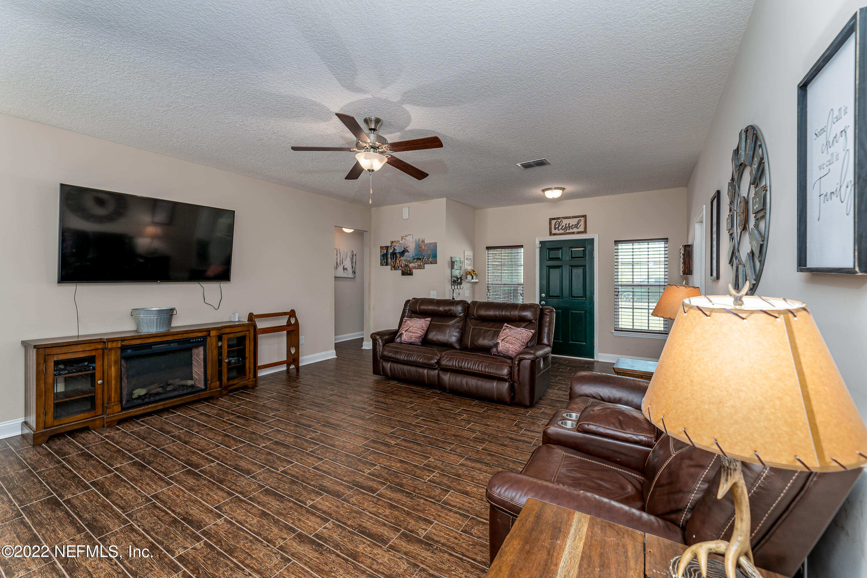 9143 McClelland Road Jacksonville, FL 32234 - Photo 10 of 37 a living room with furniture and a flat screen tv