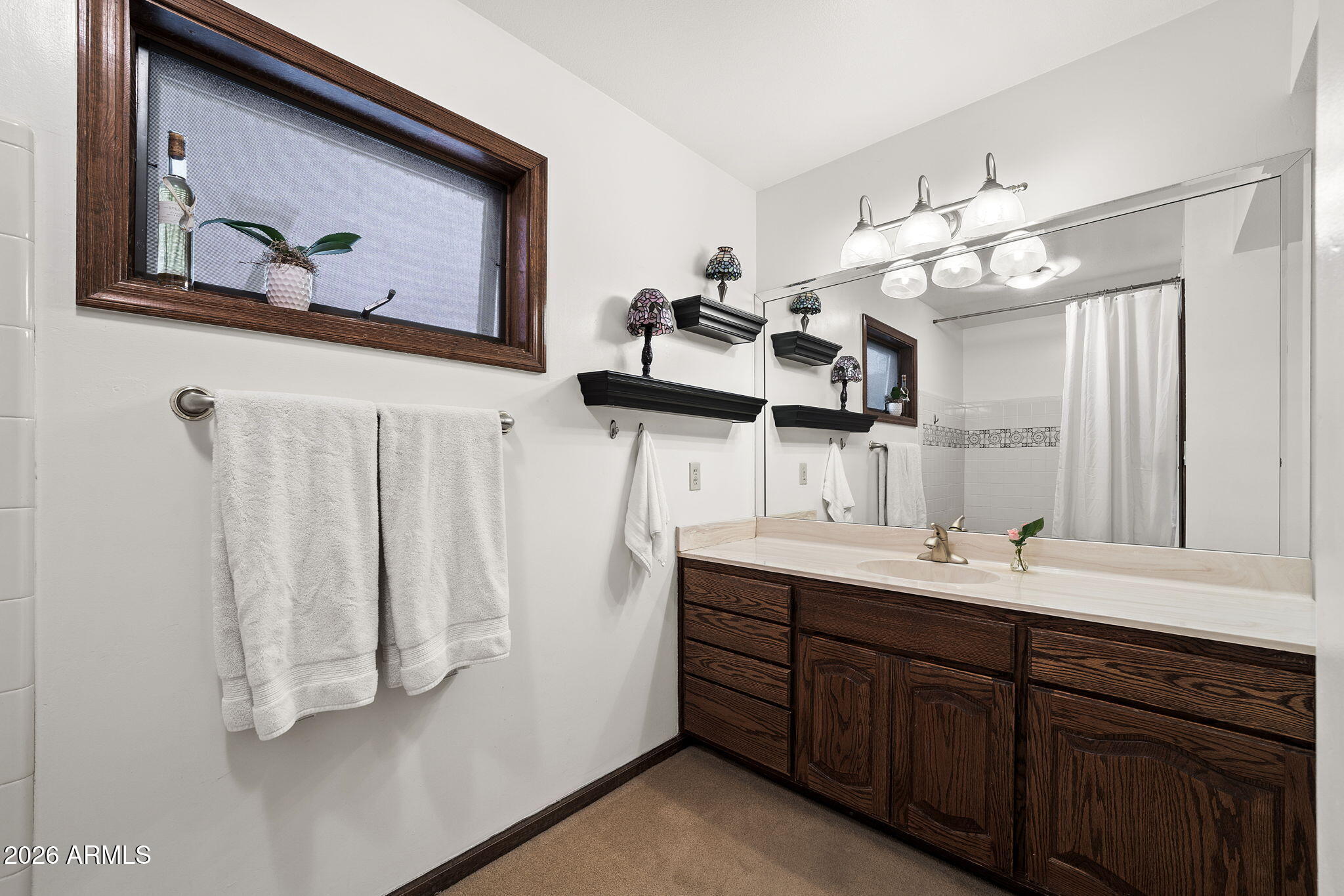 2029 East Lockwood Street Mesa, AZ 85213 - Photo 6 of 23 a bathroom with a double vanity sink and a mirror