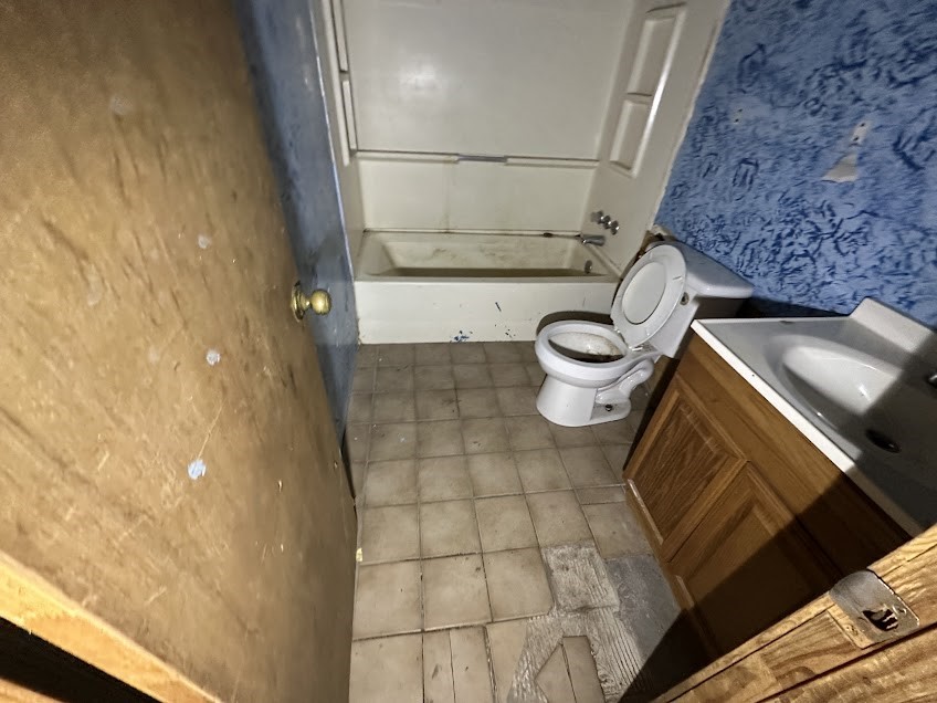 105 Lodge Street Ore City, TX 75683 - Photo 7 of 9 a bathroom with a sink and a mirror
