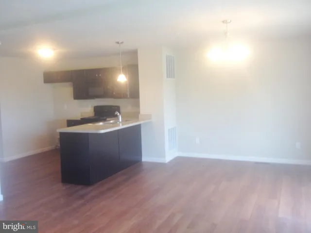 a room with wooden floor and bathroom