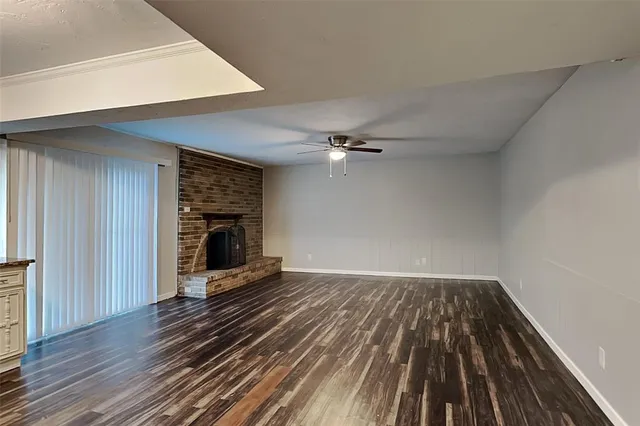 wooden floor in an empty room with a fireplace
