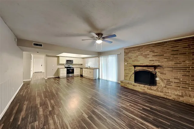 wooden floor in an empty room with a fireplace