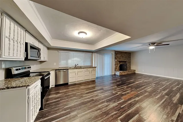 a kitchen with stainless steel appliances granite countertop a stove a sink and a refrigerator