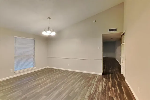 a view of a livingroom with wooden floor and a window