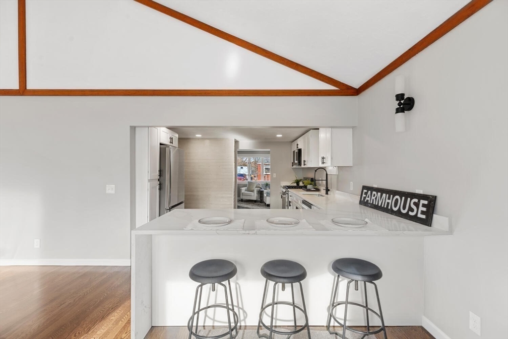 49 Butler Avenue Stoneham, MA 02180 - Photo 15 of 36 a view of kitchen island with sink and refrigerator