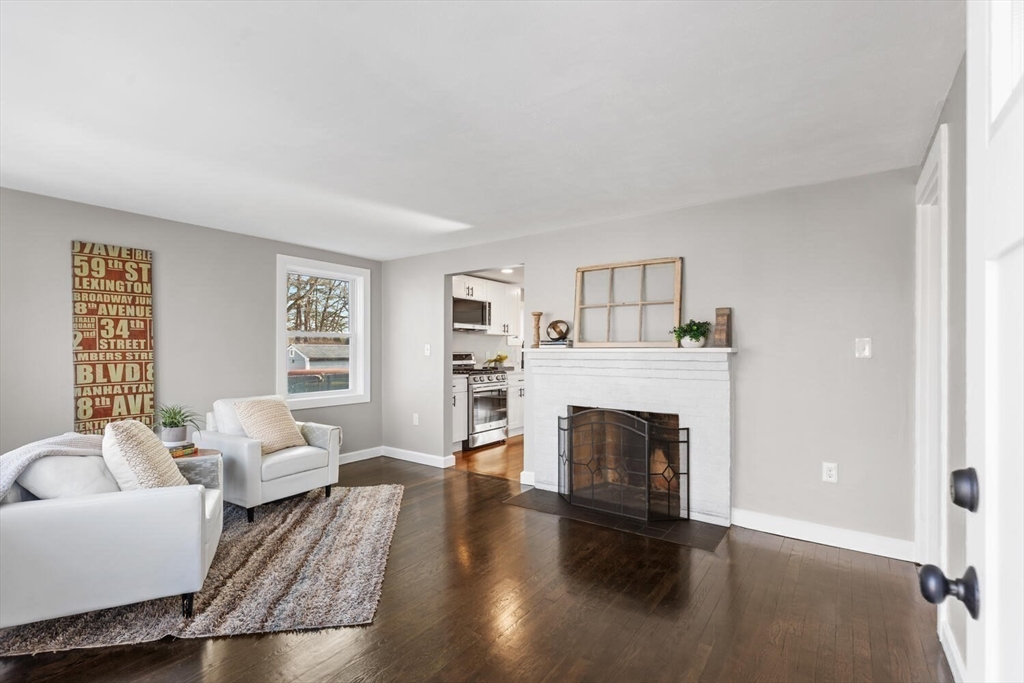 49 Butler Avenue Stoneham, MA 02180 - Photo 19 of 36 a living room with furniture and a fireplace
