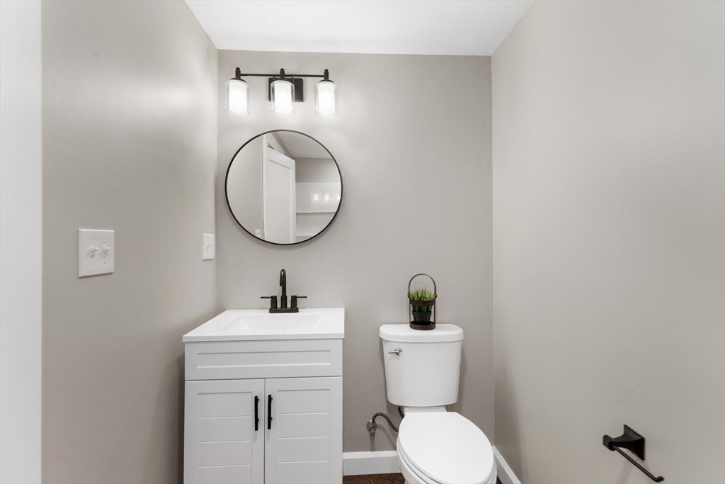 49 Butler Avenue Stoneham, MA 02180 - Photo 29 of 36 a bathroom with a toilet a sink and mirror