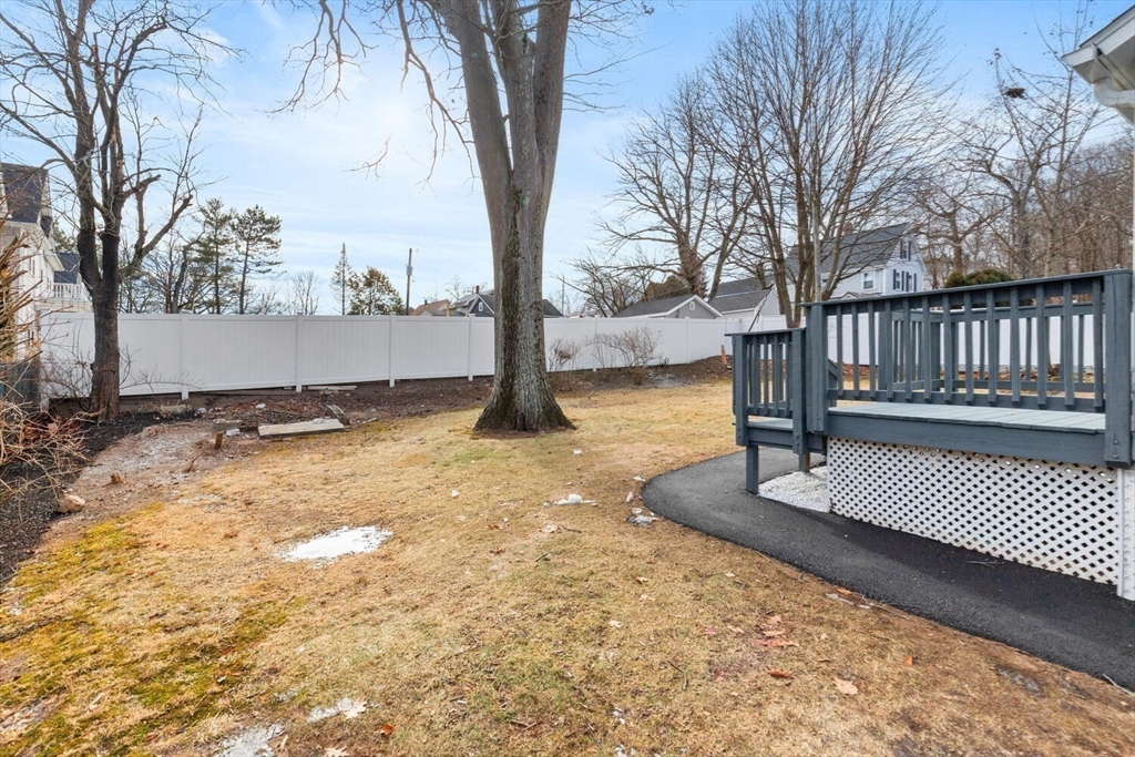 49 Butler Avenue Stoneham, MA 02180 - Photo 34 of 36 a view of a yard with wooden fence