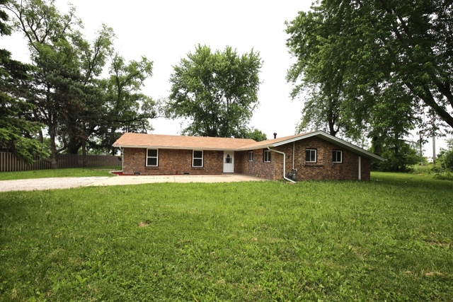 404 Hillside Road Joliet, IL 60433 - Photo 1 of 10 a view of a yard in front of a house with large trees