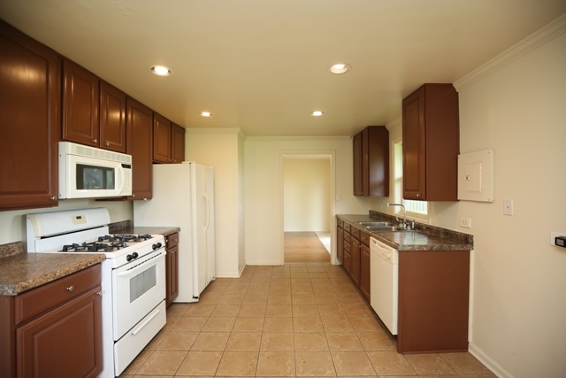 404 Hillside Road Joliet, IL 60433 - Photo 3 of 10 a kitchen with stainless steel appliances a stove top oven and a refrigerator