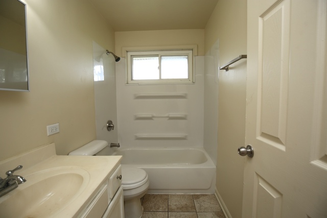 404 Hillside Road Joliet, IL 60433 - Photo 5 of 10 a bathroom with a sink toilet and shower
