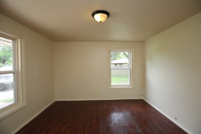 404 Hillside Road Joliet, IL 60433 - Photo 8 of 10 an empty room with wooden floor and windows