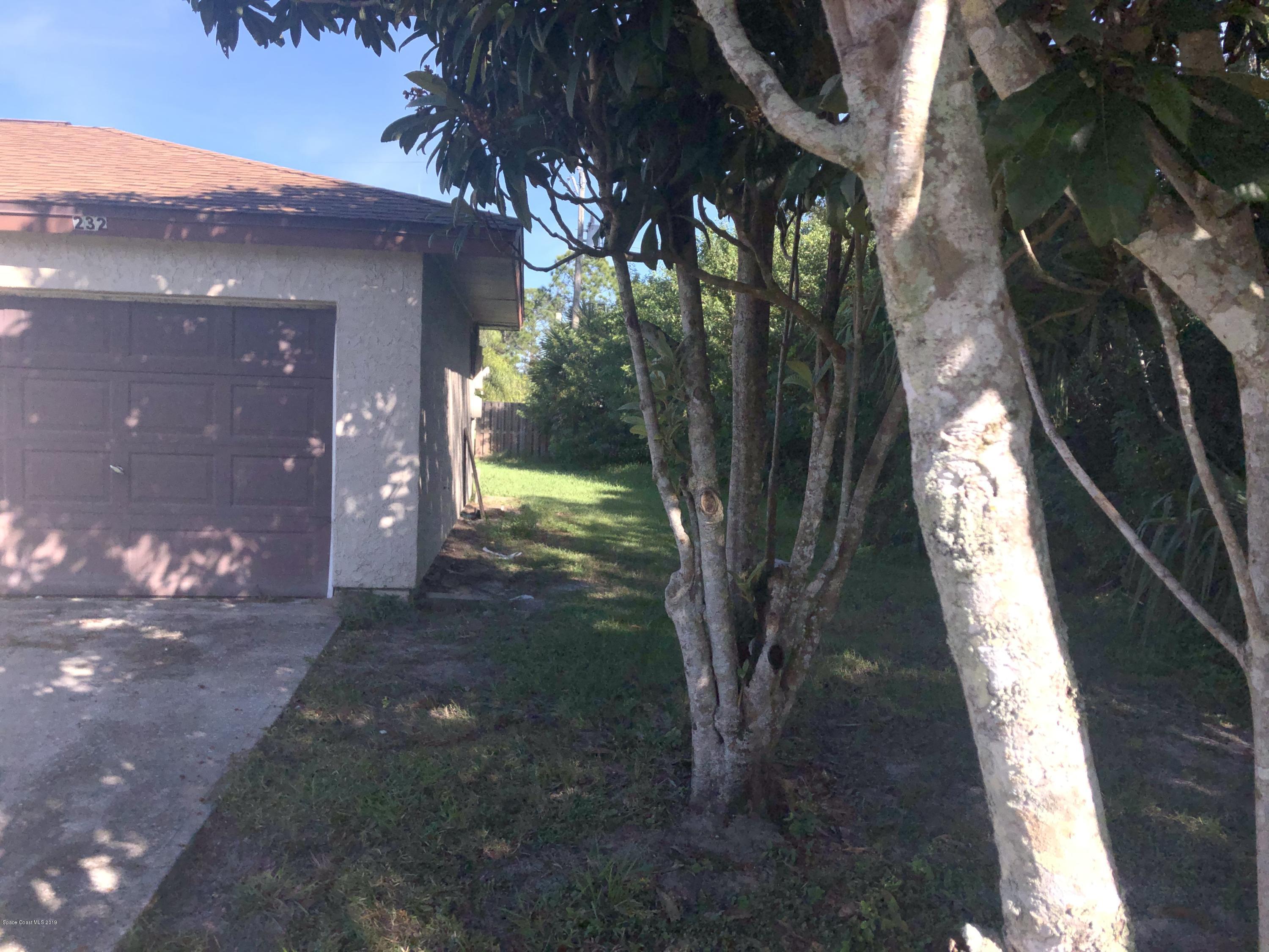 232 Abalone Road Northwest Palm Bay, FL 32907 - Photo 2 of 18 a view of backyard of a house