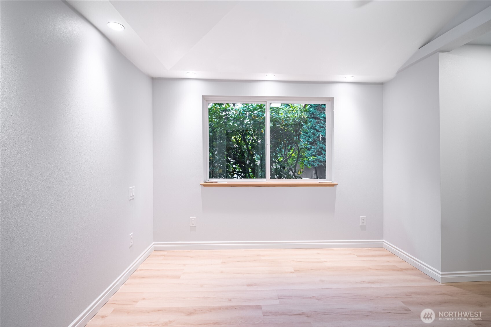 2802 Garden Court, Unit A Steilacoom, WA 98388 - Photo 13 of 29 an empty room with wooden floor and windows