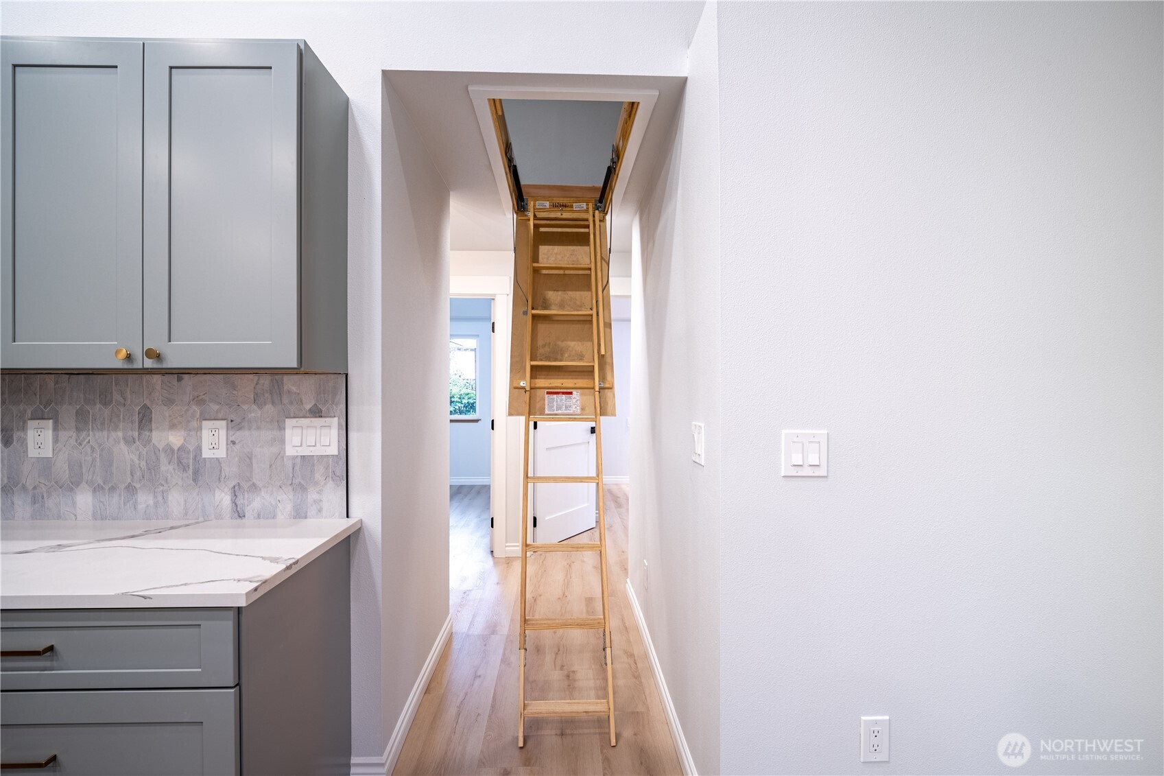 2802 Garden Court, Unit A Steilacoom, WA 98388 - Photo 20 of 29 a hallway with sliding door and wooden floor