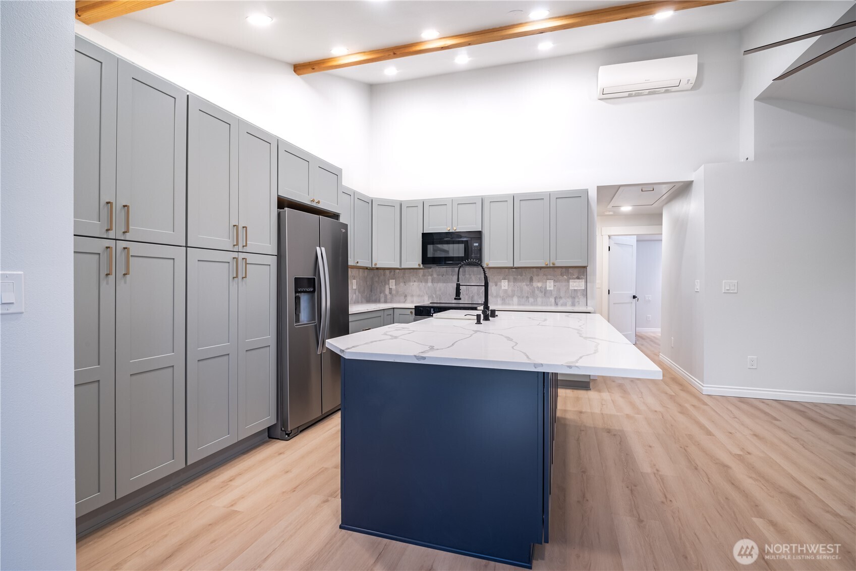 2802 Garden Court, Unit A Steilacoom, WA 98388 - Photo 4 of 29 a kitchen with kitchen island a sink stainless steel appliances and refrigerator