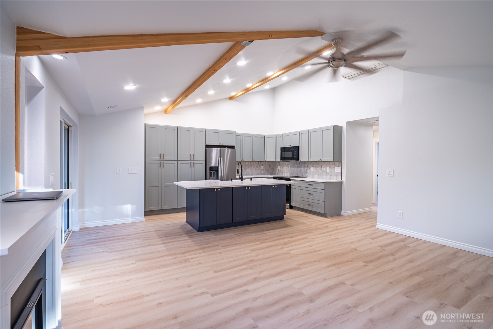2802 Garden Court, Unit A Steilacoom, WA 98388 - Photo 9 of 29 a large kitchen with kitchen island a sink stainless steel appliances and cabinets