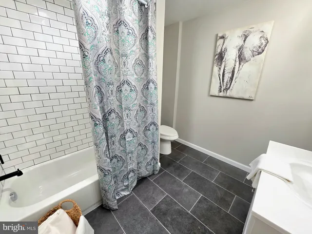 a bathroom with a bathtub and shower