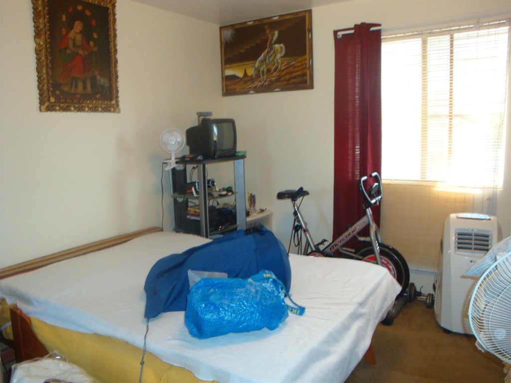 488 D Street Chula Vista, CA 91910 - Photo 16 of 19 a bed sitting in a bedroom next to a window