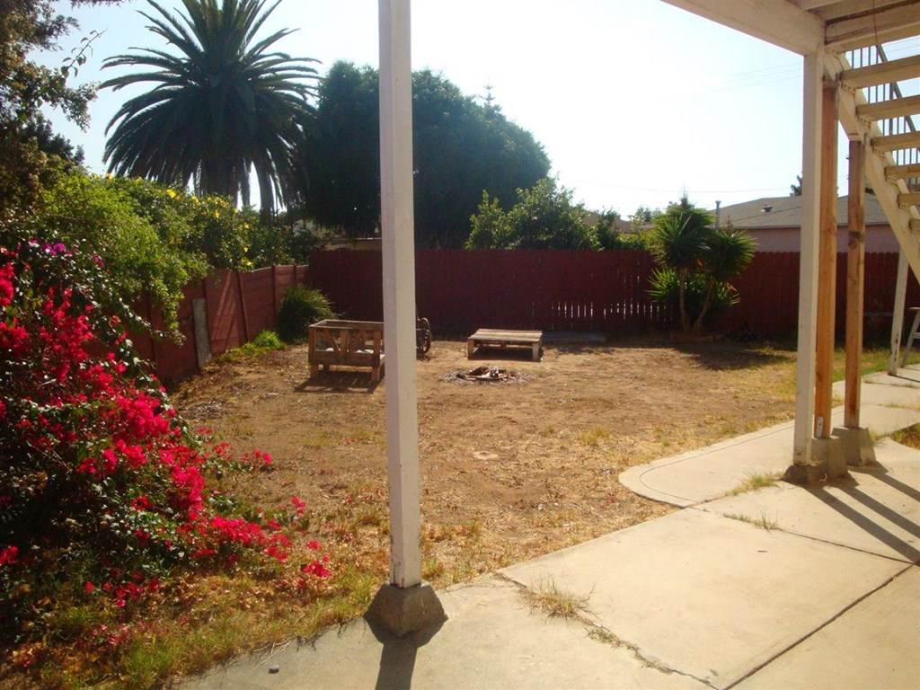 488 D Street Chula Vista, CA 91910 - Photo 18 of 19 a backyard of a house with table and chairs plants