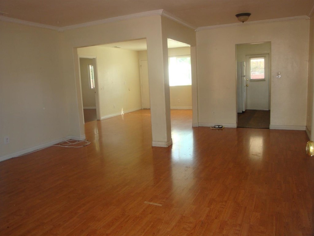 488 D Street Chula Vista, CA 91910 - Photo 2 of 19 an empty room with wooden floor and windows
