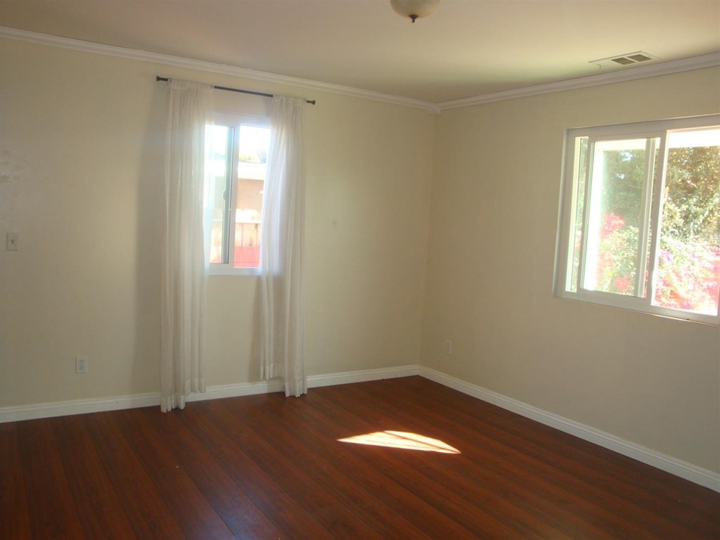 488 D Street Chula Vista, CA 91910 - Photo 4 of 19 an empty room with wooden floor and windows