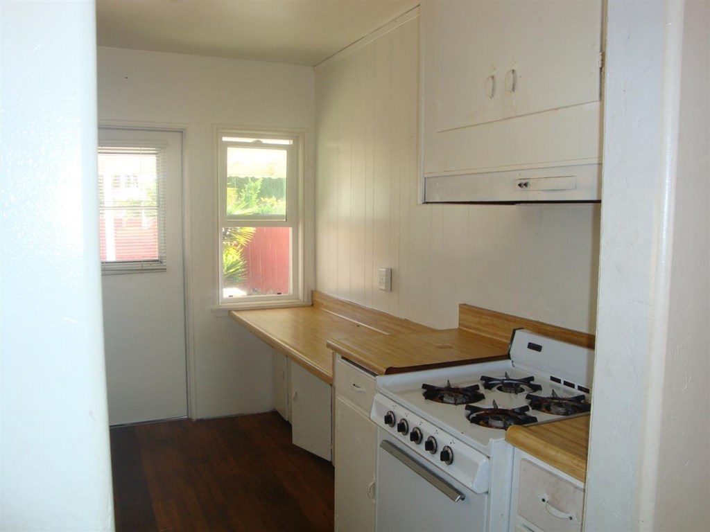 488 D Street Chula Vista, CA 91910 - Photo 7 of 19 a kitchen that has a stove and a granite counter tops