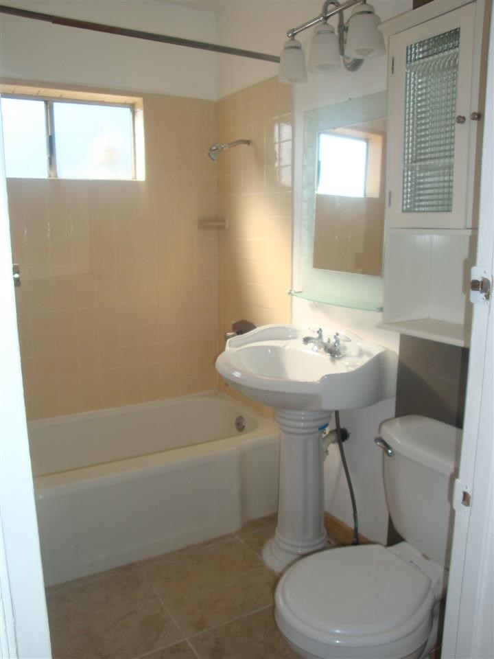 488 D Street Chula Vista, CA 91910 - Photo 8 of 19 a bathroom with a sink a toilet and shower