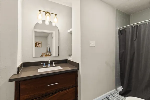 a bathroom with a sink vanity and a mirror