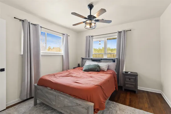 a bedroom with a bed dresser and a window