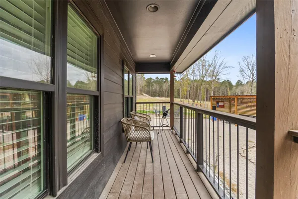 a view of a balcony with wooden floor