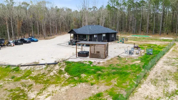 a view of a house with backyard and sitting area