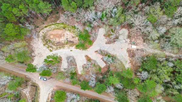 an aerial view of a house with a yard and garden