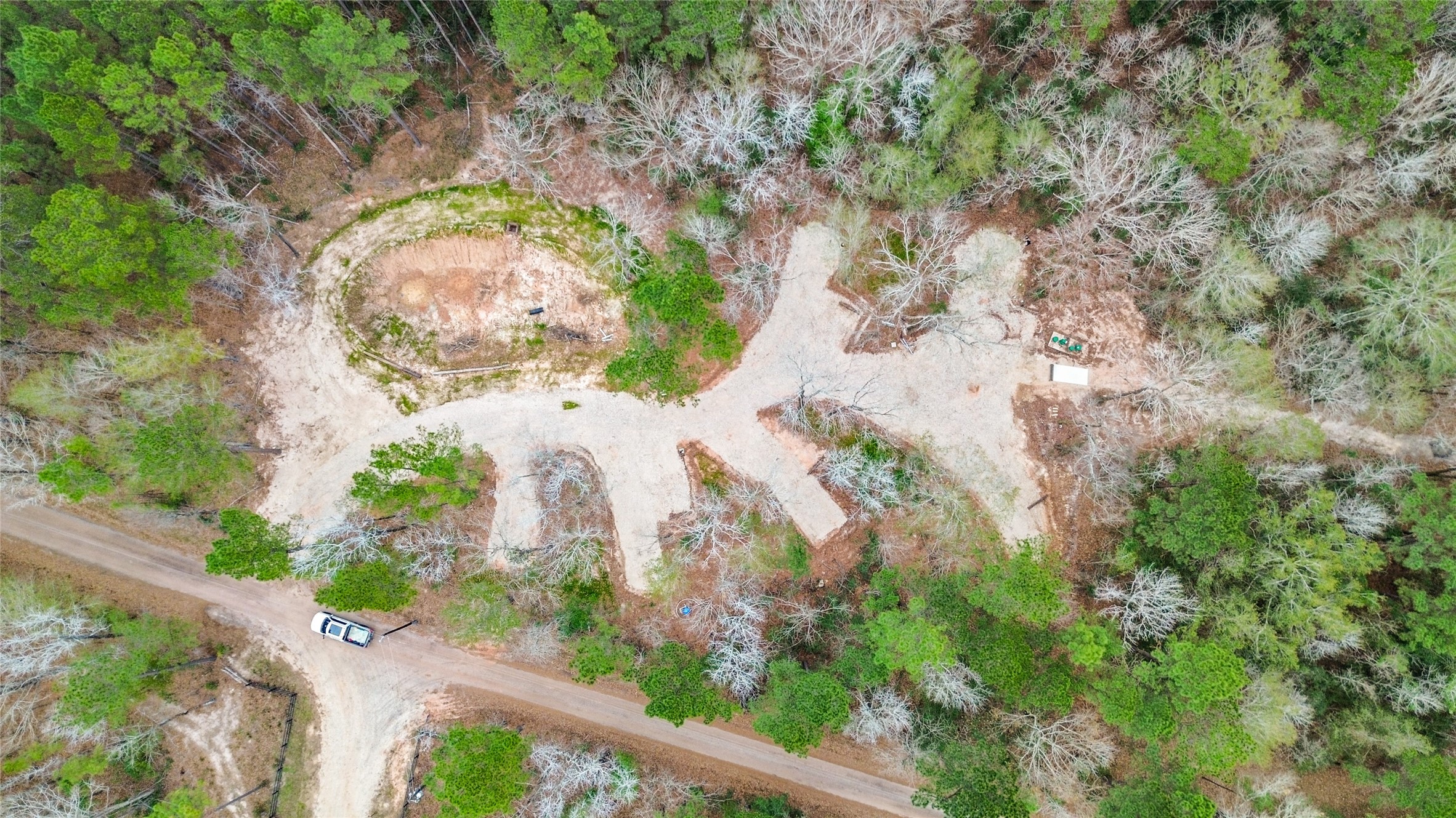 180 Jordan Road Point Blank, TX 77364 - Photo 33 of 38 an aerial view of a house with a yard and garden