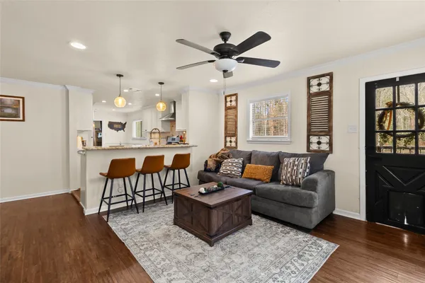 a living room with furniture wooden floor and a table