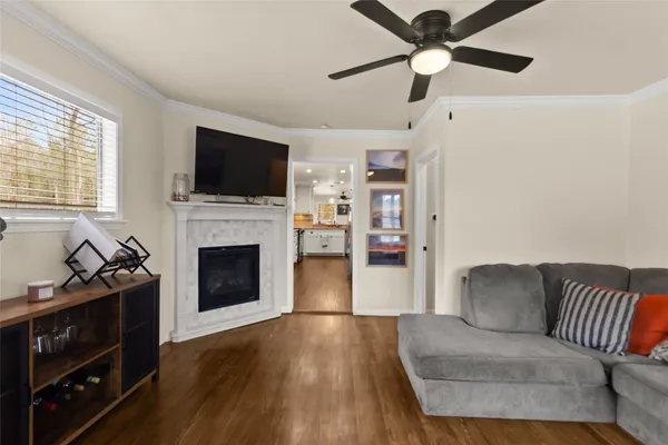 a living room with furniture a flat screen tv and a fireplace