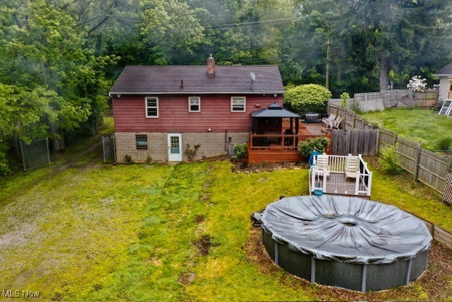 3364 Cormany Road Akron, OH 44319 - Photo 4 of 44 Rear view of house with a gazebo, a chimney, a wooden deck, and a fenced backyard