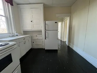 a kitchen with a white cabinets and a stove