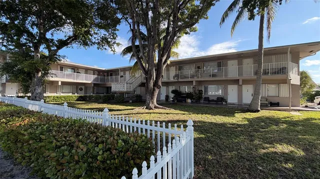 a view of a house with swimming pool and sitting area