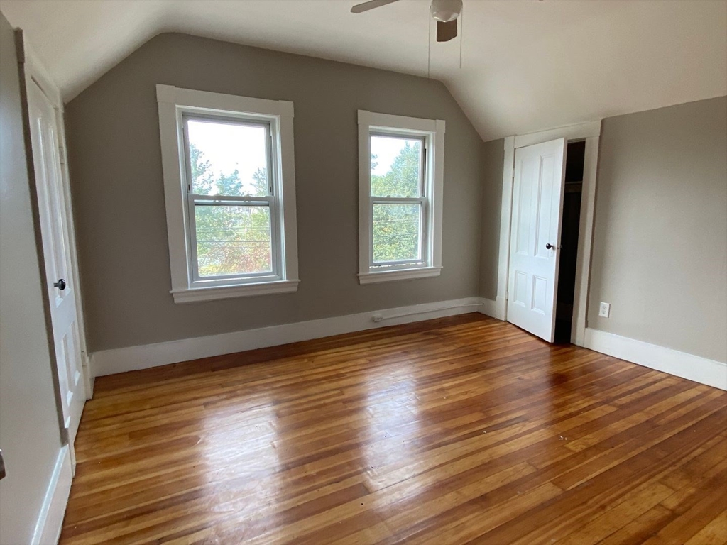 99 Mammoth Road, Unit 2 Lowell, MA 01854 - Photo 4 of 7 a view of an empty room with wooden floor and a window