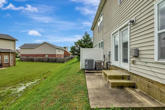 a view of a house with backyard and sitting area