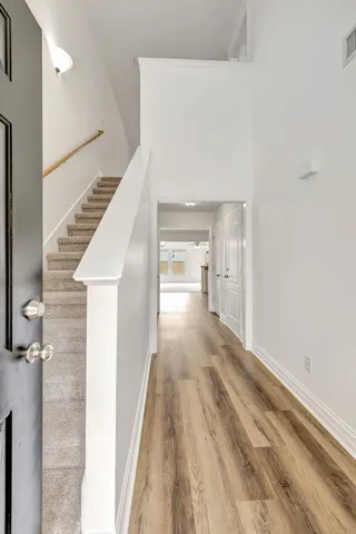a view of a hallway view with wooden floor and staircase
