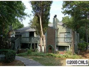 1606 Sharon Road West, Unit 34W Charlotte, NC 28210 - Photo 1 of 8 a front view of a house with a garden