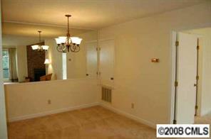 1606 Sharon Road West, Unit 34W Charlotte, NC 28210 - Photo 4 of 8 a view of a hallway with a chandelier