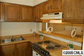1606 Sharon Road West, Unit 34W Charlotte, NC 28210 - Photo 5 of 8 a kitchen with a sink stove and cabinets