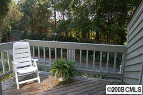 1606 Sharon Road West, Unit 34W Charlotte, NC 28210 - Photo 8 of 8 a view of a chair and table in the backyard
