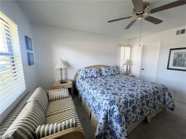 a bedroom with bed and a window