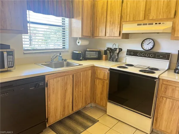 a kitchen with stainless steel appliances a stove a sink and a microwave