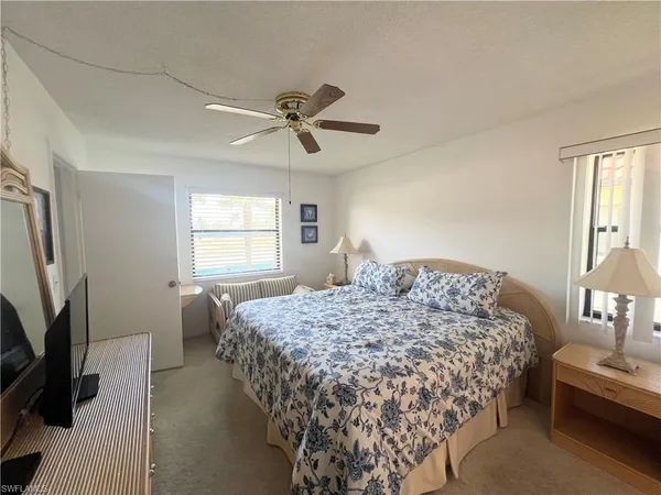 a bedroom with a bed a dresser and a window