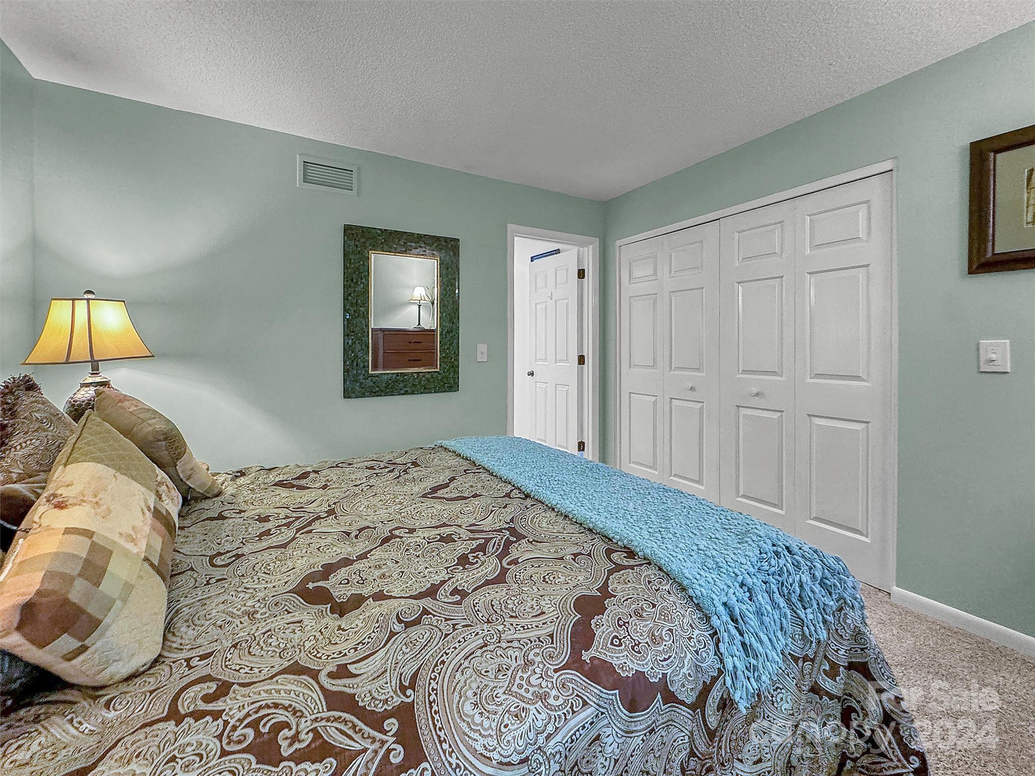 87 Willow Road, Unit B2 Waynesville, NC 28786 - Photo 23 of 38 a bedroom with a bed and a window
